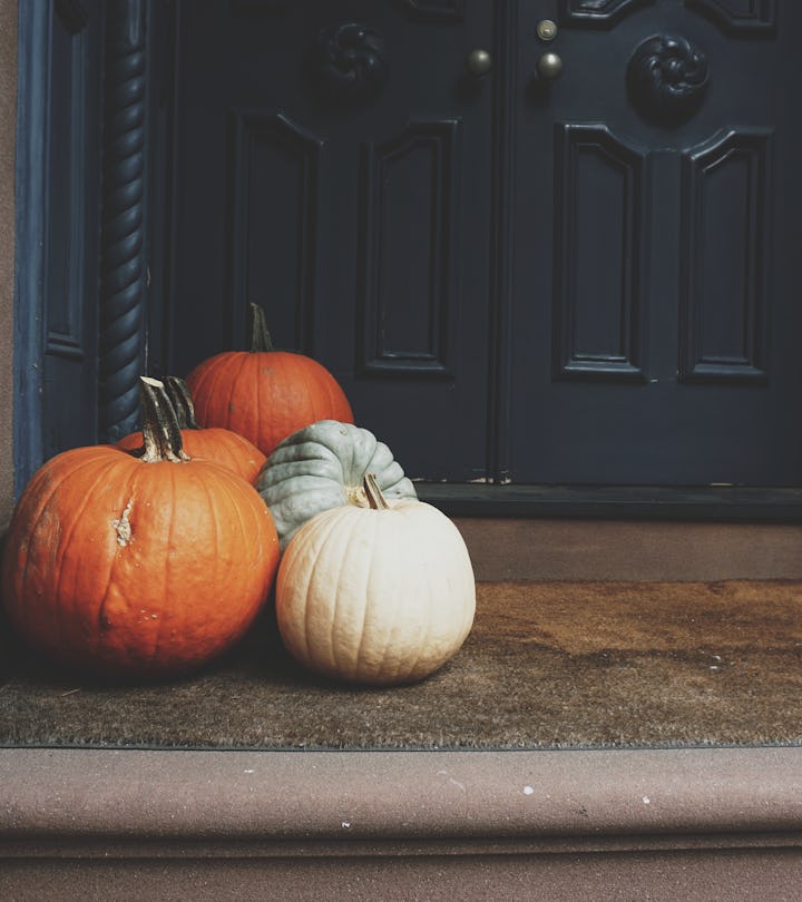 assorted fall pumpkins sitting on a front porch