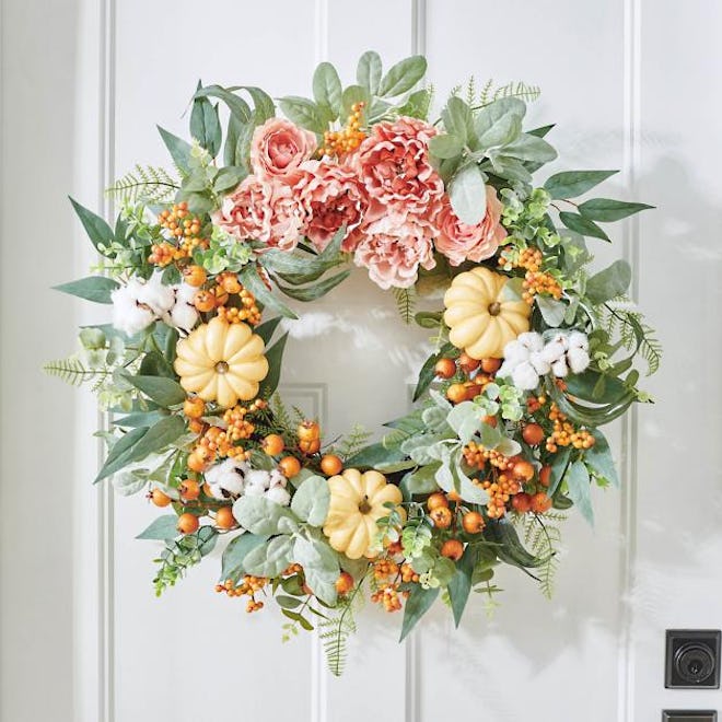 wreath with mini pumpkins, peonies, and eucalyptus