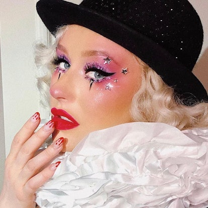 Christina Aguilera in clown halloween costume with bloody nails