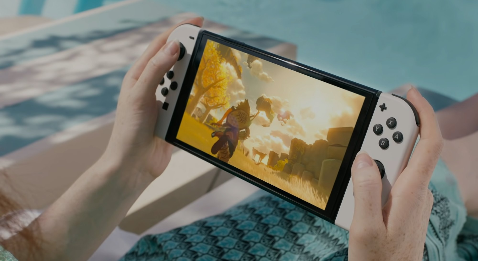 Playing the new Nintendo Switch OLED by the pool.