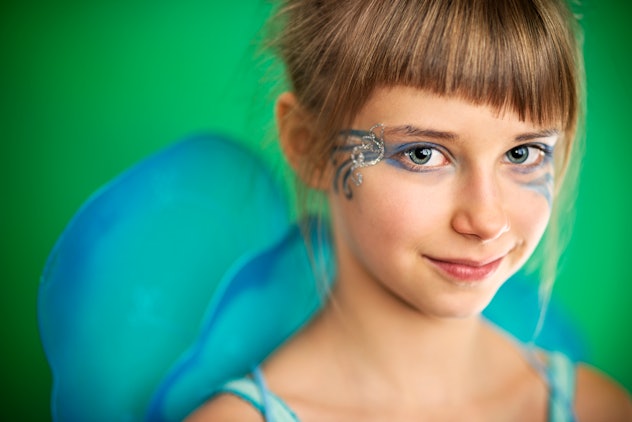 Young girl looking at camera, with swirly eye makeup