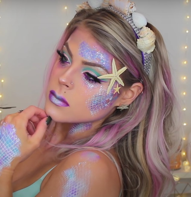 Woman modeling mermaid makeup 