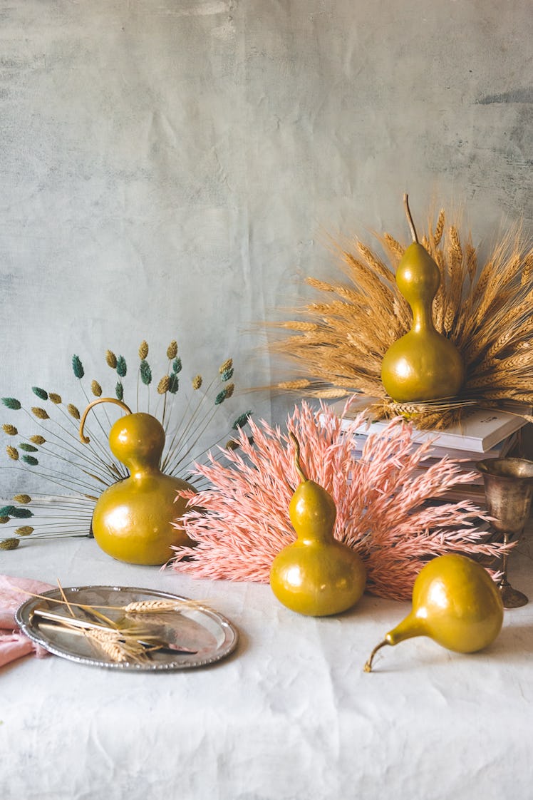Table with DIY dried flower turkey gourds