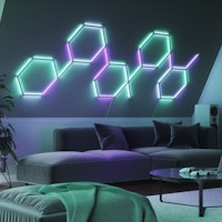 Nanoleaf Lines installed on a wall above a sofa.