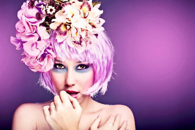 Woman wearing flower crown, with pink wig and pastel fairy makeup