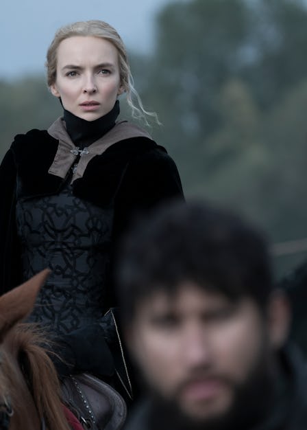 the actress Jodie Comer dressed in renaissance garb on the back of a horse