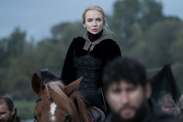 the actress Jodie Comer dressed in renaissance garb on the back of a horse
