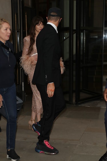 Chris Martin and Dakota Johnson seen leaving The Corinthia Hotel ahead of the "The Lost Daughter" UK...