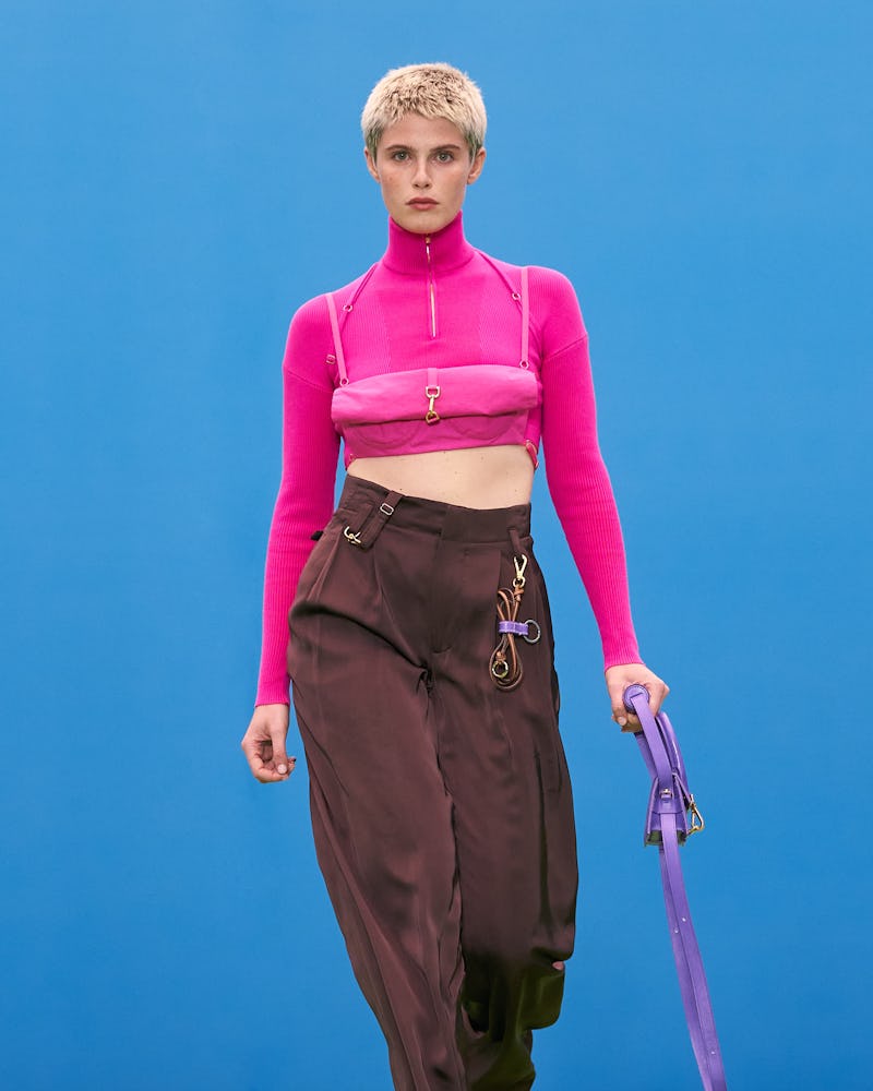 Model wears gorpcore-inspired cargo pants and a pink turtleneck during Jaquemus' Fall/Winter 2021 ru...