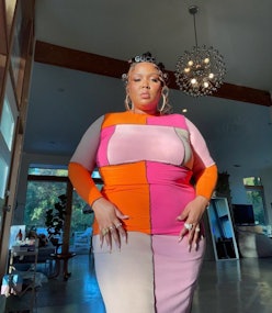 Lizzo wearing a colorful dress. 