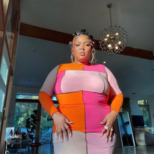 Lizzo wearing a colorful dress. 