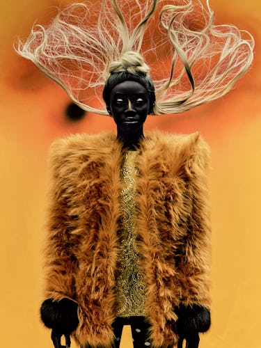 Binta Diop wears an Yves Saint Laurent by Anthony Vaccarello coat and tunic; tights from Ib Kamara S...