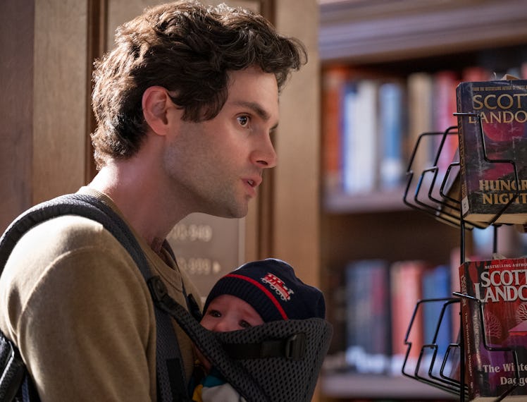 Penn Badgley holding a baby on his chest