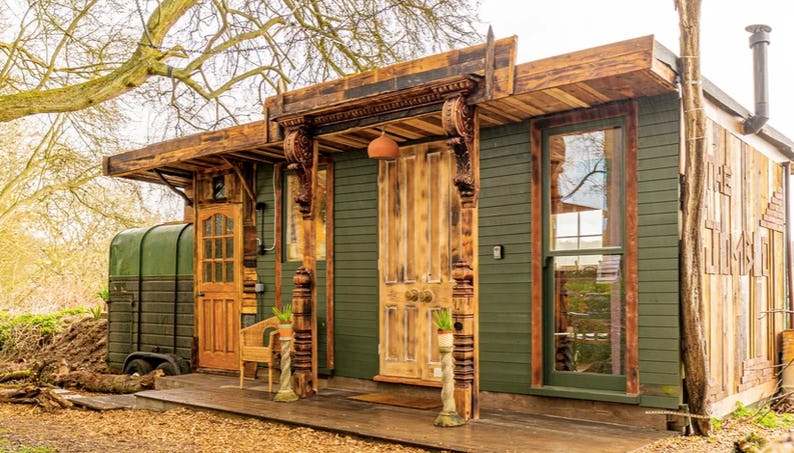 A sage and brown wooden cottage in Croft Farm, Hertfordshire