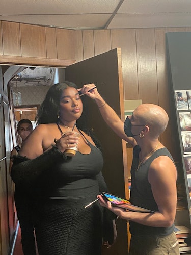 Makeup artist Marcelo Gutierrez puts a finishing touch on Precious Lee.