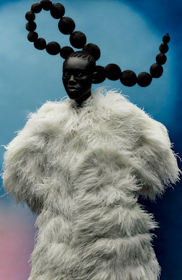 Mensah wears a Dolce & Gabbana coat.