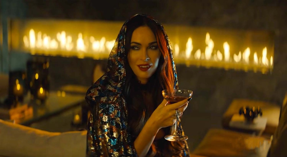 Megan Fox holds a martini glass in Night Teeth