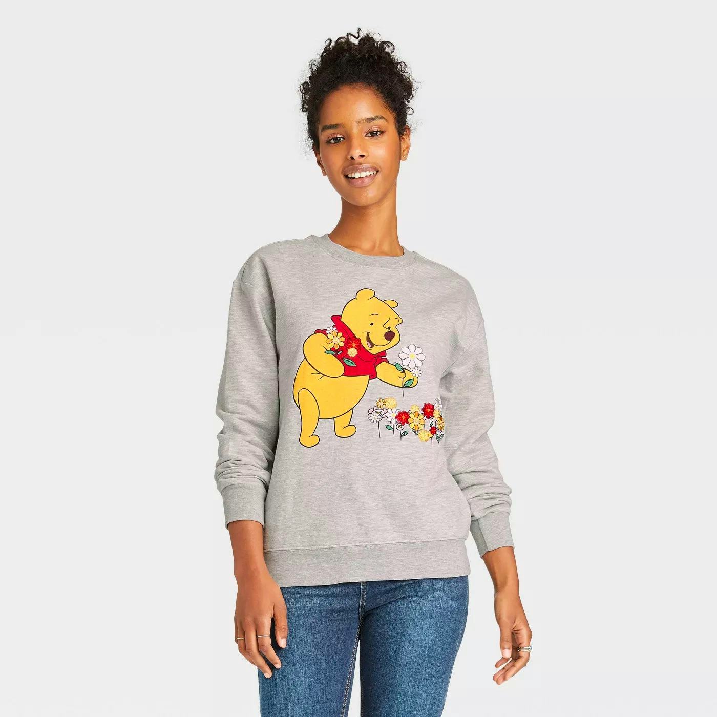 A woman wears some of Disney's 'Winnie the Pooh' 95th anniversary merch.