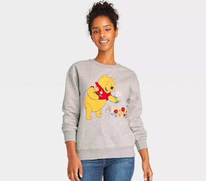 A woman wears some of Disney's 'Winnie the Pooh' 95th anniversary merch.