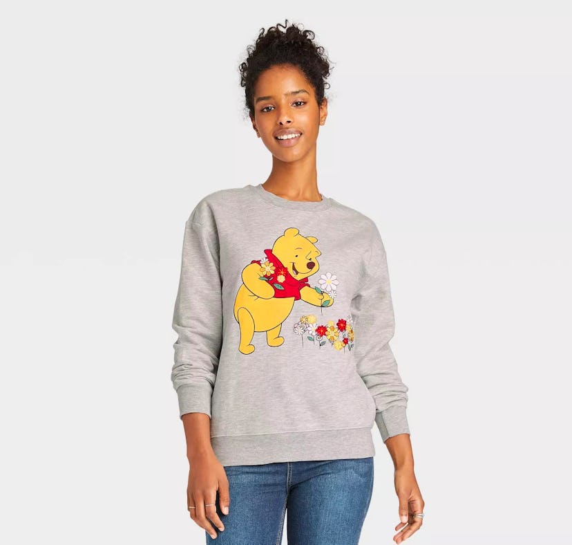 A woman wears some of Disney's 'Winnie the Pooh' 95th anniversary merch.