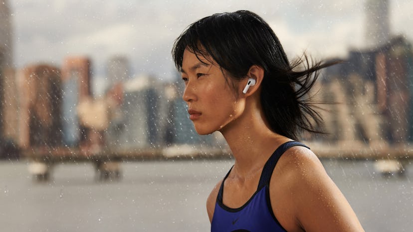 A woman runs while wearing AirPods 3. Here's how Airpods 3 are different from the previous generatio...