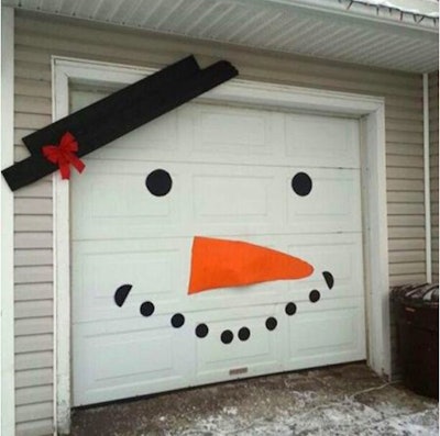 Image of a garage door covered in decals that create the face of a snowman.
