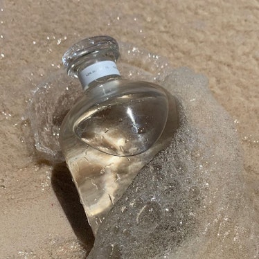 Air company glass bottle on beach