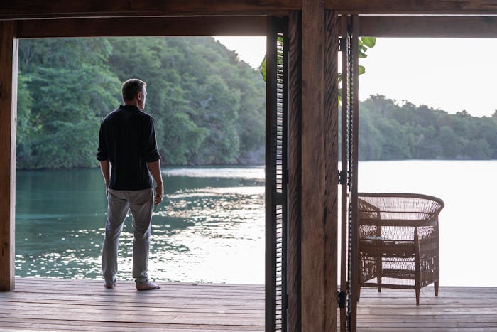 James Bond staring out at a lake thinking about the past 
