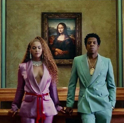 Beyoncé and Jay-Z wearing matching suits from the Apeshit music video. 
