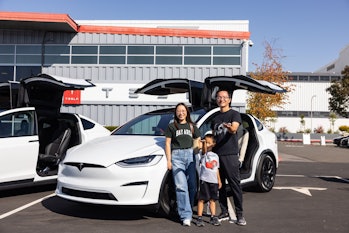 Family standing by new Model X