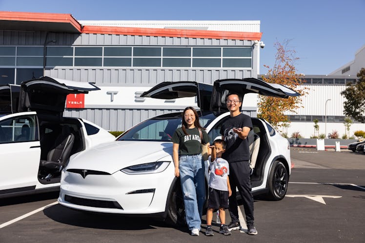 Family standing by new Model X