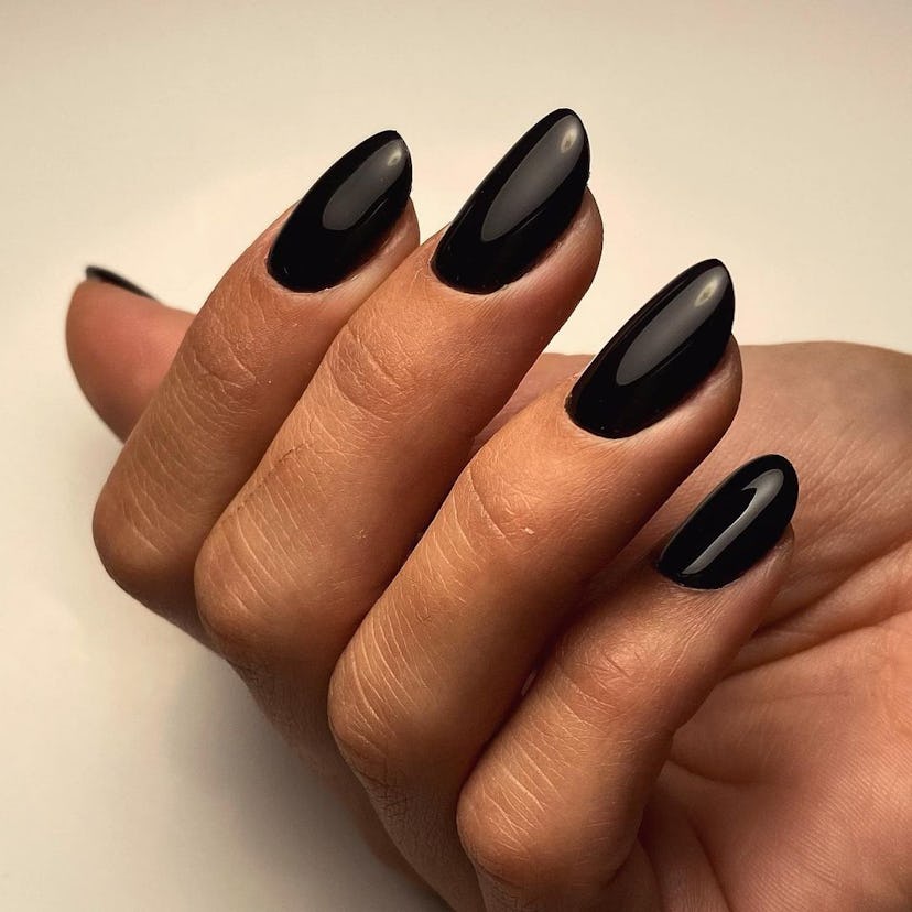 One way to rock dark nails? With a classic black nail polish.