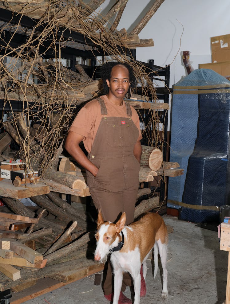 Hugh Hayden, with his dog, Mars, in his South Bronx studio.