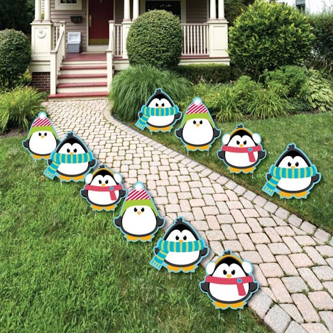 Image of Penguin lawn decorations, lining a home's walkway.
