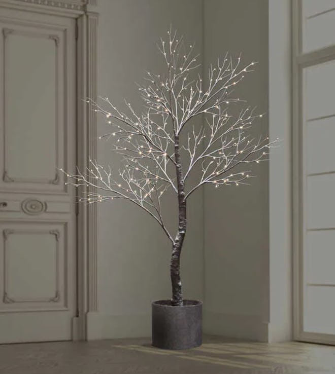 Image of an indoor potted LED tree. Slender branches are LED lit.