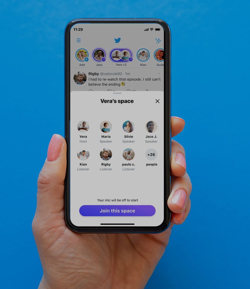 Hand holding an iPhone with Twitter Spaces on the screen.