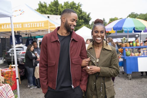 Issa and Lawrence walking through a street market in 'Insecure'