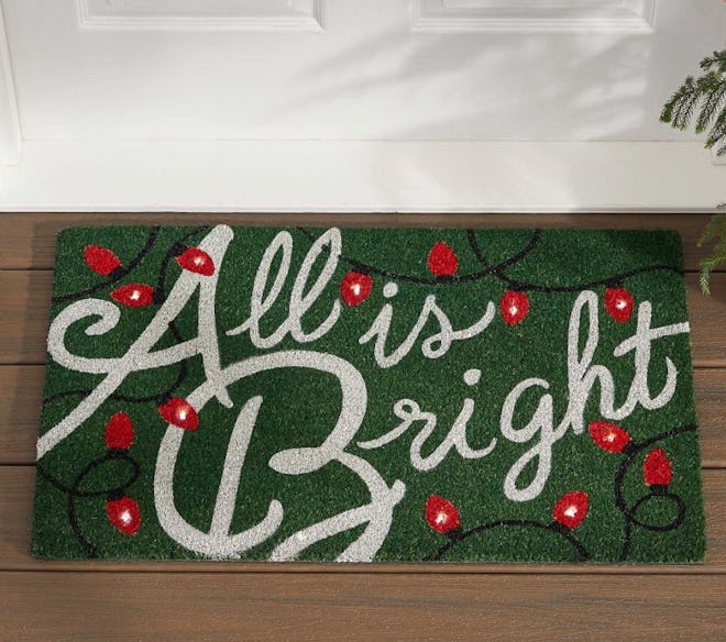 This "All Is Bright" doormat is available to order now from Pottery Barn.