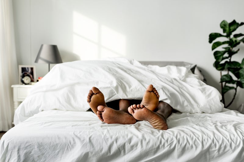 Two people in bed together.