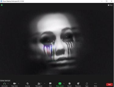 These scary Halloween Zoom backgrounds include a face with black eyes.