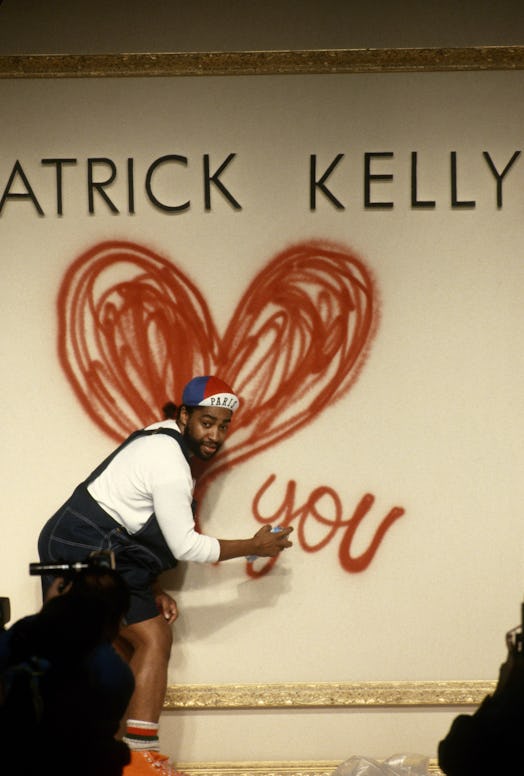 Patrick Kelly spray painting a wall