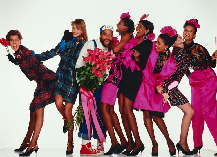 Patrick Kelly posing with seven models