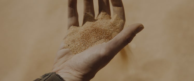 A hand holding sand in the Dune: Part Two movie