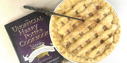 'The Unofficial Harry Potter Cookbook' and an uncooked treacle tart and magic wand