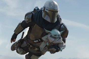 Mandalore flying while holding Baby Yoda in his arms