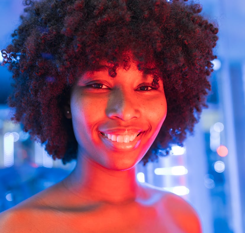 Young woman smiling during Scorpio season 2021, which will be lucky for her zodiac sign.