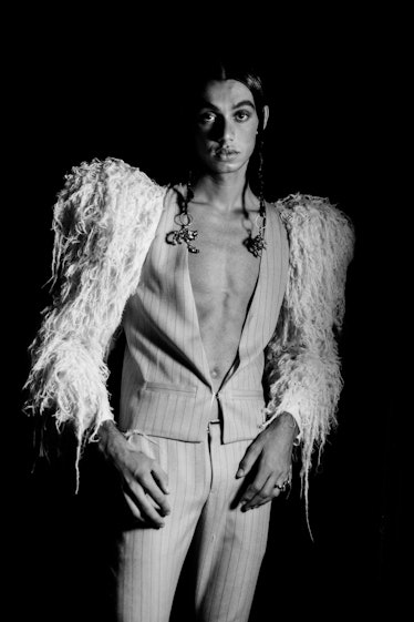model wearing feathered wings suit