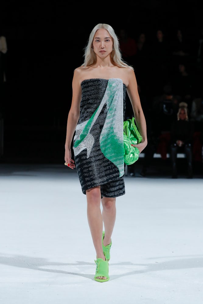 Model walking the runway in a grey and green dress at the Bottega Veneta Spring 2022 show
