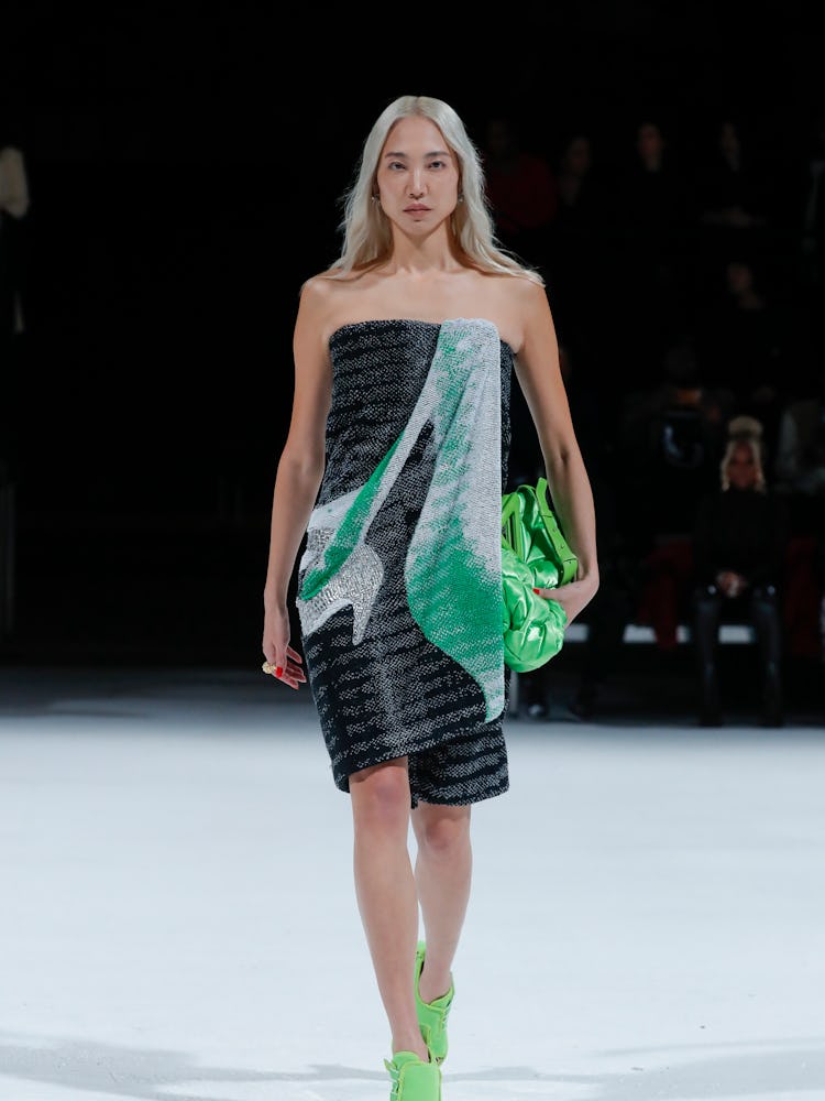 Model walking the runway in a grey and green dress at the Bottega Veneta Spring 2022 show