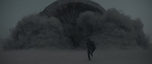 Paul Atreides (Timothée Chalamet) runs from a giant worm in 'Dune.'